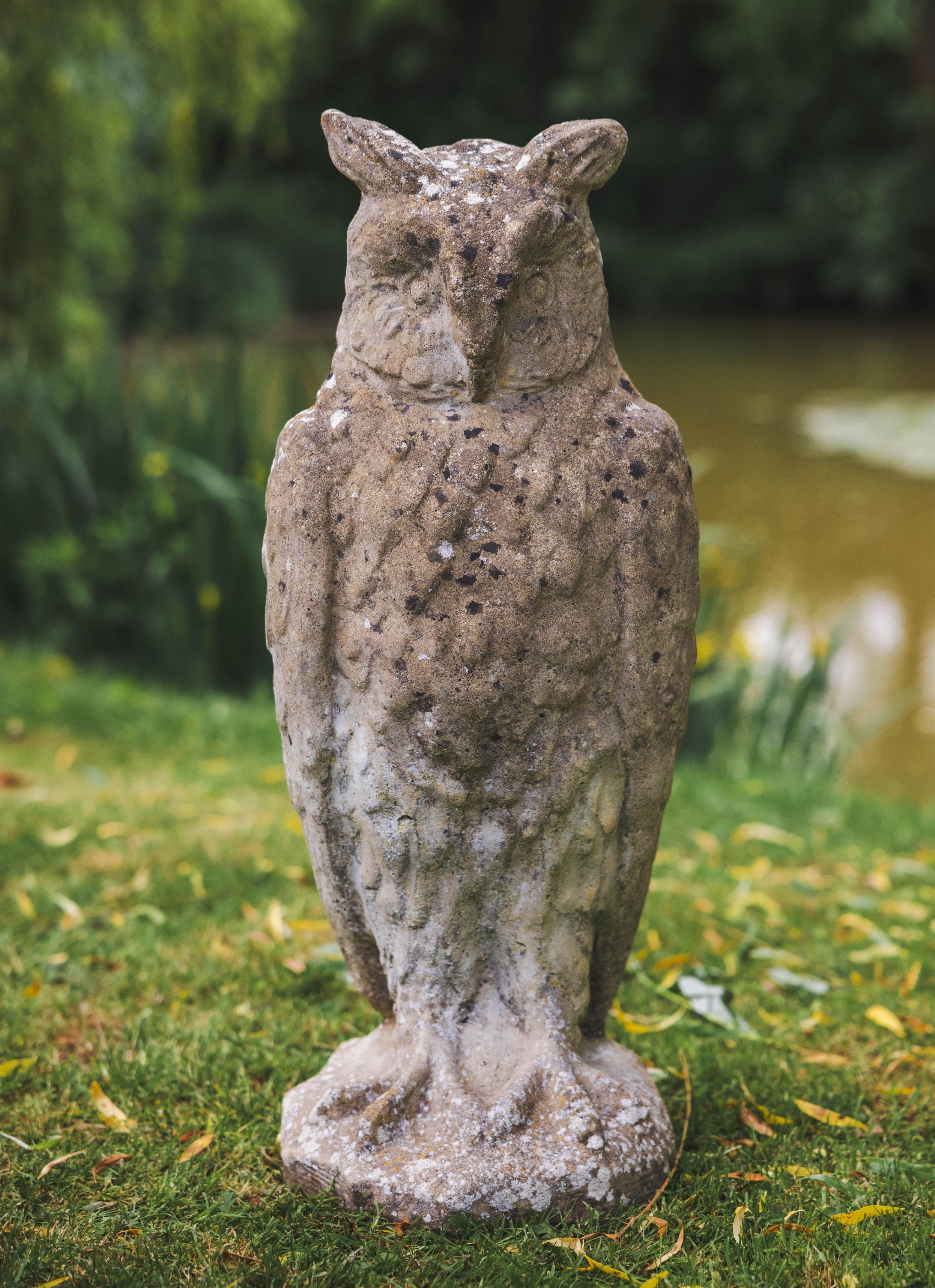 A reconstituted stone owl garden ornament, height 72cm